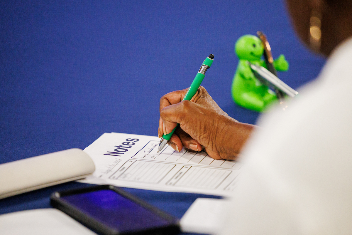 close up of person writing on notepad